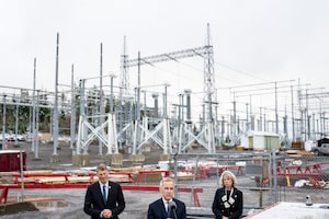 Prime Minister Mark Carney speaks as Minister of Housing and Infrastructure Gregor Robertson, left, and CEO of the Major Projects Office Dawn Farrell, right, listen during an announcement at Skeena Substation in Terrace, B.C., on Thursday, Nov. 13, 2025. THE CANADIAN PRESS/Ethan Cairns